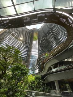 the inside of a building with many windows and plants growing on it's sides