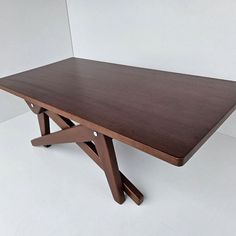 a wooden table sitting on top of a white floor