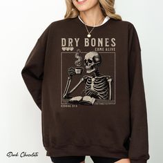 Wrap yourself in comfort with our cozy hoodie featuring a fun graphic, accompanied by the phrase "Dry Bones Come Alive," referencing Ezekiel 37:5. Available in 8 stylish colors, this hoodie is perfect for those who appreciate a blend of humor, faith, and cozy vibes. Ideal for church gatherings, Bible study groups, or simply relaxing at home with a warm drink, it's a great choice for anyone who loves a mix of spirituality and comfort. A thoughtful gift for friends and family who cherish both thei Dry Bones Come Alive, Dry Bones, Jesus Coffee, Christian Fall, Comfort Color, Fall Sweatshirt, Christian Gifts, Tshirt Colors, Color Combos