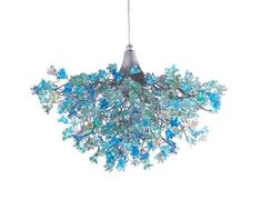 a chandelier with blue glass flowers hanging from it's sides and a light fixture in the middle