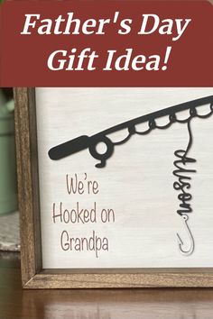 a father's day gift idea with a fishing hook and name on the frame