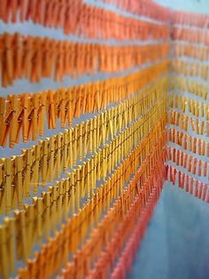 an array of orange and yellow clothes pins