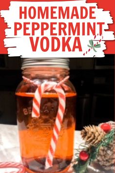 homemade peppermint vodka in a mason jar with candy canes and pine cones