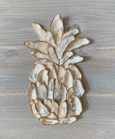 a white pineapple shaped object sitting on top of a wooden floor