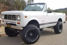 a white truck parked on the side of a road