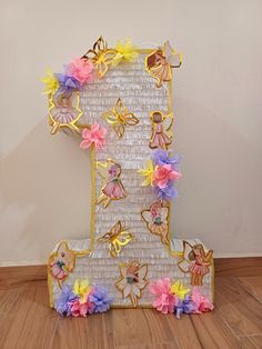 the letter i is decorated with paper flowers