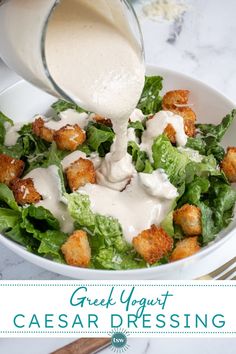 a white bowl filled with salad and dressing being poured into the salad in front of it