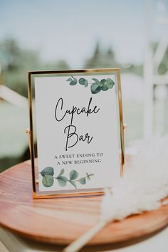 a table sign sitting on top of a wooden table