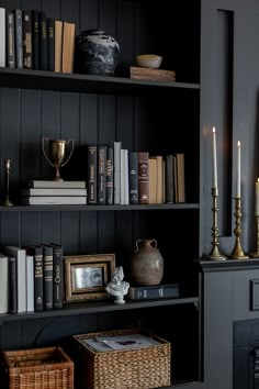 a bookshelf filled with lots of books and candles