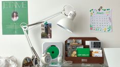 a desk with a lamp and various items on it