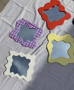 four mirrors sitting on top of a table