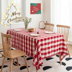 a dining room table with a red and white checkered tablecloth on the table