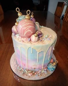 a decorated cake sitting on top of a wooden table