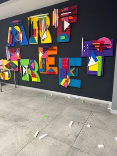 the wall is decorated with colorful pieces of art on it's sides, including letters and numbers