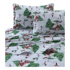 a bed with christmas themed sheets and pillows on top of it, in front of a white background