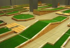 an indoor miniature golf course with artificial grass