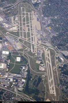 an aerial view of the airport runway and its surrounding area, taken from above in flight