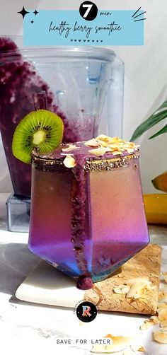 a purple drink with kiwi on the side