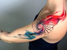 a woman's arm with an artistic tattoo design on her left arm and shoulder