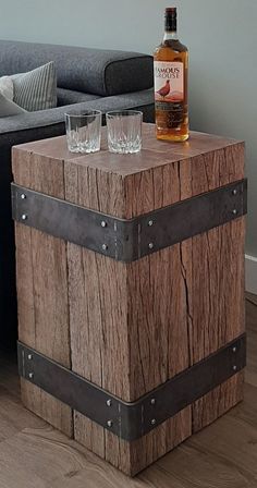 a table with two glasses on top of it next to a couch in a living room