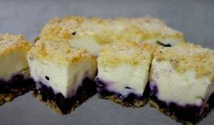 several pieces of cheesecake sitting on top of each other with blueberries in the middle