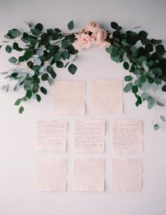 the wedding guest's names are laid out on paper with greenery and flowers