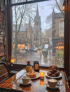 two plates of food sit on a table in front of a window overlooking a street