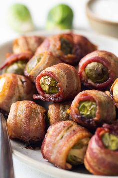 a white plate topped with bacon wrapped in jalapenos