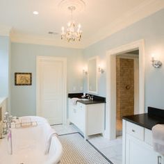 a large white bath tub sitting inside of a bathroom