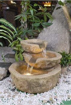 a stone fountain with water running down it