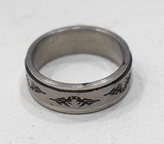 These are wonderful Stainless Steel Etched Spinner Band Ring that can be worn by Men, Women and Children. The ring has a nice shiny finish with an etched brass oxidized pattern that spins. This is a lovely statement ring. A wonderful birthday, wedding, anniversary or friendship ring to give as a gift or wear and enjoy yourself. COMES IN ASSORTED SIZES AND WILL NOT TARNISH AT BACARA WE STAND BEHIND ALL OF OUR MERCHANDISE. FULL MONEY BACK GUARANTEE WILL BE PROVIDED FOR DISSATISFIED CUSTOMERS. YOUR SATISFACTION IS OUR MAIN GOAL, AND WE THANK YOU FOR SHOPPING AT BACARA. # 39 Friendship Ring, Friendship Rings, Linking Rings, Overland Park, Handcrafted Artisan Jewelry, Stainless Steel Band, Sterling Ring, Artisan Jewelry, Statement Ring