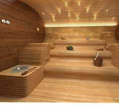 an indoor sauna with wooden benches and lights on the ceiling is pictured in this image