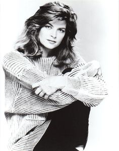 a black and white photo of a woman with her arms crossed