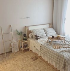 a bed sitting in a bedroom next to a window