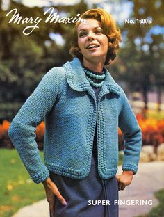 a woman wearing a blue knitted jacket and skirt with her hands on her hips