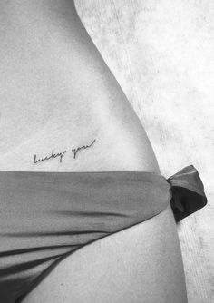 a woman's stomach with a tattoo that reads, lucky girl