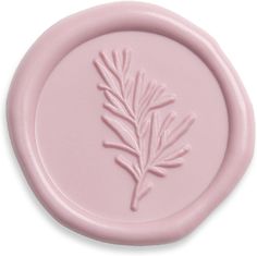 a pink wax stamp with a pine branch on it