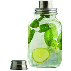 a mason jar filled with limeade and mints next to a stainless steel lid