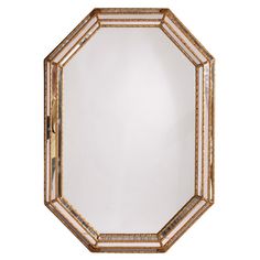 an octagonal mirror with gold trimmings on the edges and a white back ground