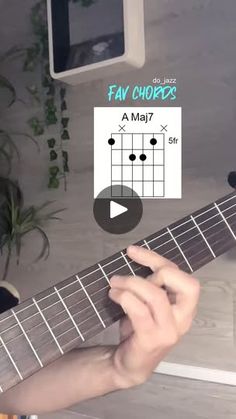 someone is playing the guitar chords on their computer screen, and it looks like they are learning how to play them