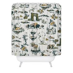 a shower curtain with animals and trees on it's side, in front of a white background