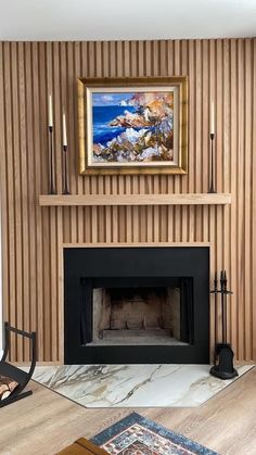 a living room with a fire place and painting on the wall