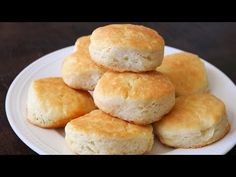 a white plate topped with biscuits on top of a wooden table