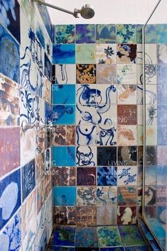 a tiled shower with blue and brown tiles