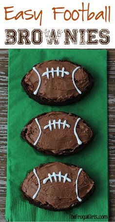 three chocolate football cookies sitting on top of a green napkin