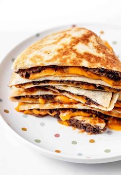 a stack of quesadillas sitting on top of a white plate