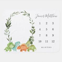 a baby's birth calendar with dinosaurs and leaves on the front, in watercolor