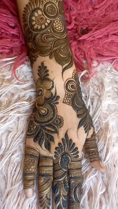 the hand is decorated with henna and flowers