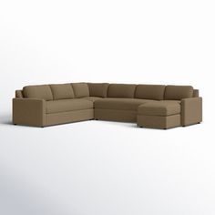 a large sectional couch sitting on top of a white floor next to a chair and ottoman