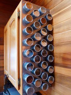 a wall mounted spice rack filled with spices